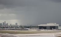 Miami International Airport (MIA) - Miami northeast ramp with storm forming over Downtown - by Florida Metal