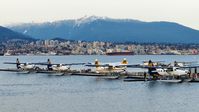 Vancouver Harbour Water Airport (Vancouver Coal Harbour Seaplane Base) - Harbour Air terminal in Coal Harbour in the early spring evening.  City of North Vancouver across Vancouver Harbour in the background. - by M.L. Jacobs