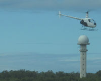 Port Elizabeth Airport - helicopter ZS-RLU passing Tower, from Terminal building - by Neil Henry