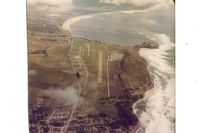 Half Moon Bay Airport (HAF) - Half Moon Bay airport in 1976 looking south. Notice the half moon shape water south of airport.Princeton at south end of airport (aircraft parking) is a very nice place to visit & eat at.Was my home base for six months till summer fog became untenable!! - by S B J