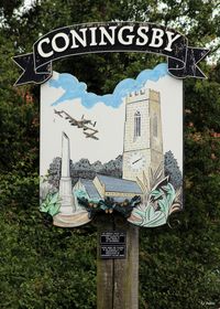 RAF Coningsby Airport, Coningsby, England United Kingdom (EGXC) - Situated on the public road outside the Battle of Britain Memorial Flight (BBMF) at RAF Coningsby, a village sign shows the strong link with the RAF. - by Clive Pattle