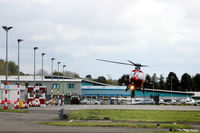 Dundee Airport, Dundee, Scotland United Kingdom (EGPN) - Eastwards facing shot of the apron at Dundee EGPN with a Northern Lighthouse EC135 (G-CGPI) hovering to land. - by Clive Pattle