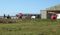 Swansea Airport, Swansea, Wales United Kingdom (EGFH) - A police and two air ambulance emergency services helicopters on the apron by the Wales Air Ambulance base at Hangar 1. - by Roger Winser