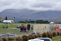 Queenstown Airport, Queenstown New Zealand (NZQN) - Two aircraft on the same active runway: The one on the left is taxing for take-off, and the one on the right just landed and is backtracking to the exit. - by Micha Lueck