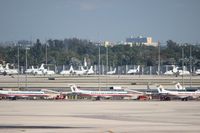 Miami International Airport (MIA) - American Eagle line up with biz jets in background - by Florida Metal