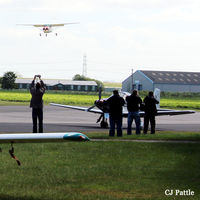 EGBR Airport - Spotters doing what they do best at Breighton EGBR during the 'Radial Fly-in' - I don't know what difference holding your camera up in the air above your head makes ! - by Clive Pattle