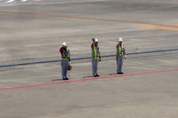 Tokyo International Airport (Haneda), Ota, Tokyo Japan (RJTT) - I love that friendly gesture of ground staff waving flights good-bye. I have only ever seen it in Japan and in Hawai'i - by Micha Lueck