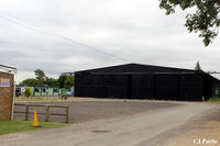 Peterborough/Sibson Airport, Peterborough, England United Kingdom (EGSP) - A view of one of the surviving WWII hangars, still occupied by aircraft, with the parachuting Cafe and Clubroom to the left at Sibson EGSP - by Clive Pattle