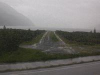 Whittier Airport (IEM) - Whittier airport as seen during pouring rain while riding the Alaskan Railroad - by Timothy Aanerud