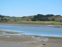 Raglan Aerodrome Airport, Raglan New Zealand (NZRA) - View from across river. A grass strip. No based aircraft but gets regular visitors in summer. Annual fly in very popular. Public footpath crosses runway and easy for photos and parking available next to fence. - by magnaman