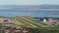Moffett Federal Afld Airport (NUQ) - Flying over Moffett Federal Airfield, Mountain View, CA with the Blue Angels parked on the left side of the image. - by Chris Leipelt