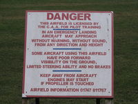 Compton Abbas Airfield - sign next to public footpath style across runway! - by magnaman