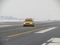 Boise Air Terminal/gowen Fld Airport (BOI) - Volvo friction car at work. Vehicle has a 5th wheel between the axels and a computer to determine runway friction values during snow removal. - by Gerald Howard