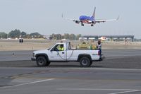 Boise Air Terminal/gowen Fld Airport (BOI) - Outside maintenance crews spraying to keep the weeds at bay. A never ending job. - by Gerald Howard