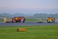 Manchester Airport, Manchester, England United Kingdom (EGCC) - man airport fire trucks waiting to cross runway 23R for 23L  - by andysantini