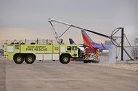 Boise Air Terminal/gowen Fld Airport (BOI) - ARFF unit practicing with water prob to puncture aircraft skin and introduce a water fog spray
into the aircraft's interior.  - by Gerald Howard