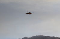 Santa Paula Airport (SZP) - CROMAN helicopter with Phos Chek sling load dumped, returning to SZP Firebase - by Doug Robertson
