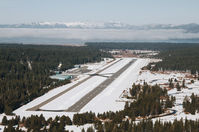 Lake Tahoe Airport (TVL) - South Lake Tahoe Airport facing NW with Lake Tahoe covered by fog just ahead of the airport. - by Chris Leipelt