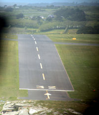 St. Mary's Airport, St. Mary's, England United Kingdom (EGHE) - Short finals for 32 St Marys Isles of Scilly in Twin Otter G-CEWM.  Since my 1987 pictures (qv) the grass has been replaced by tarmac runway.  The slope here is quite apparent, see also the shots at ground level from the threshold. - by Pete Hughes