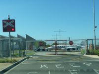 Essendon Airport - A Learjet 36, N82GG, taxying through the level crossing gates over Wirraway Road, Essendon Airport. - by red750