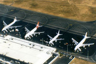 Brisbane International Airport - APOV of 'Old Eagle Farm' International Airport YBBN on 12Aug1992. The line-up on the ramp (from front right to left) is a JAL Super Resort Express B747-246B, an Air New Zealand B767, a Qantas B747-338, and a British Airways B747-436.
 - by Walnaus47