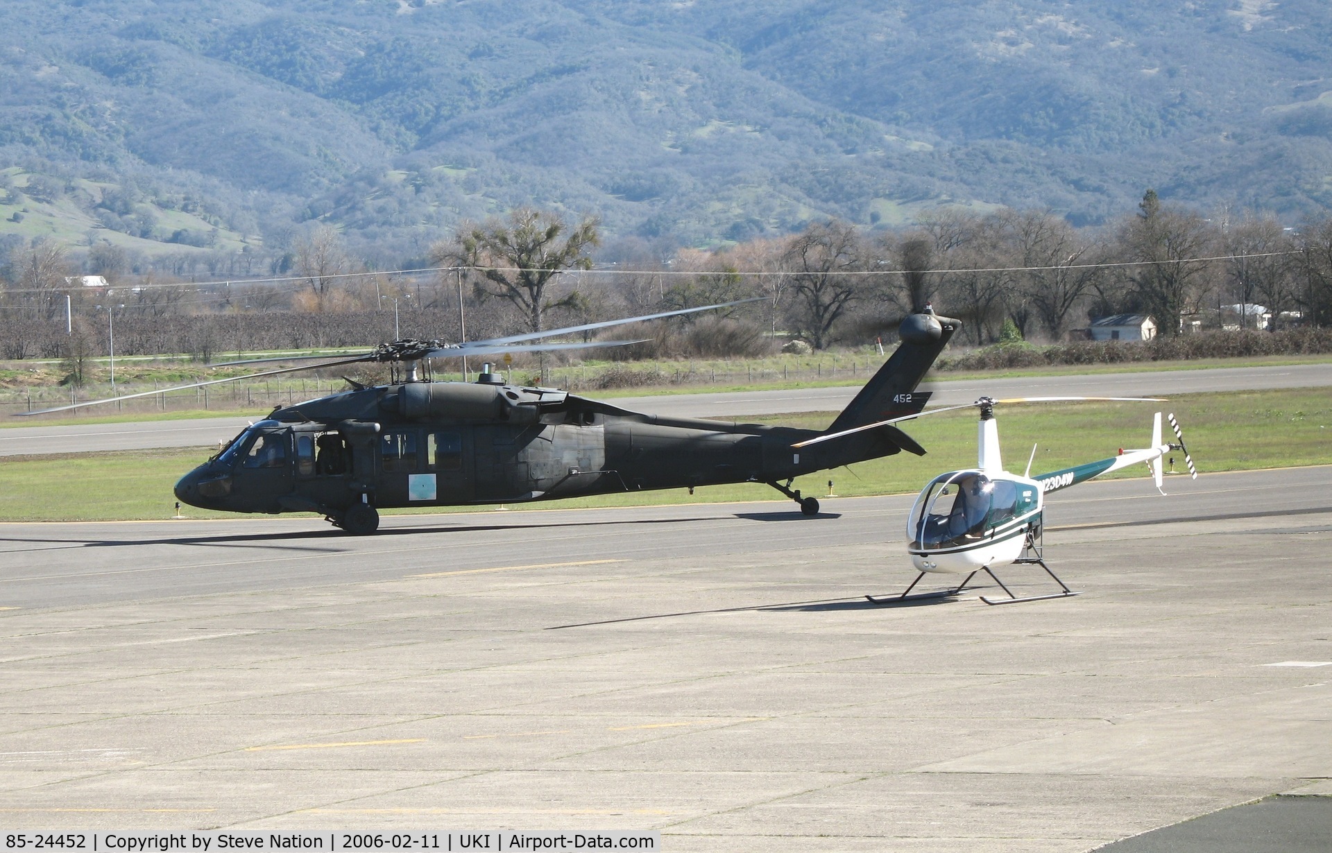 85-24452, 1985 Sikorsky UH-60A Black Hawk C/N 70934, CA ARNG UH-60A taxying w/1991 Robinson R22 BETA at Ukiah, CA