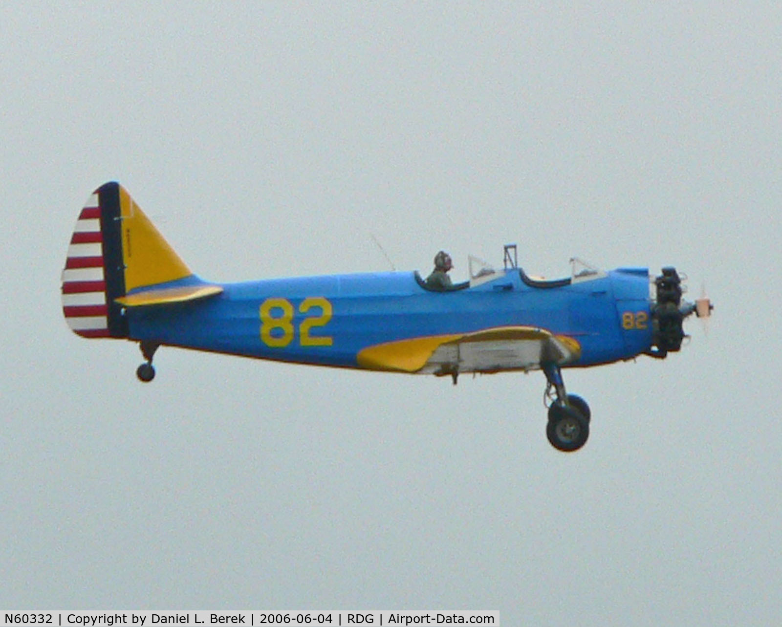N60332, 1946 Fairchild (St. Louis) PT-23A Cornell (M-62C) C/N 225SL, Bright blue and yellow Cornell trainer contrasts against a brooding, overcast sky.