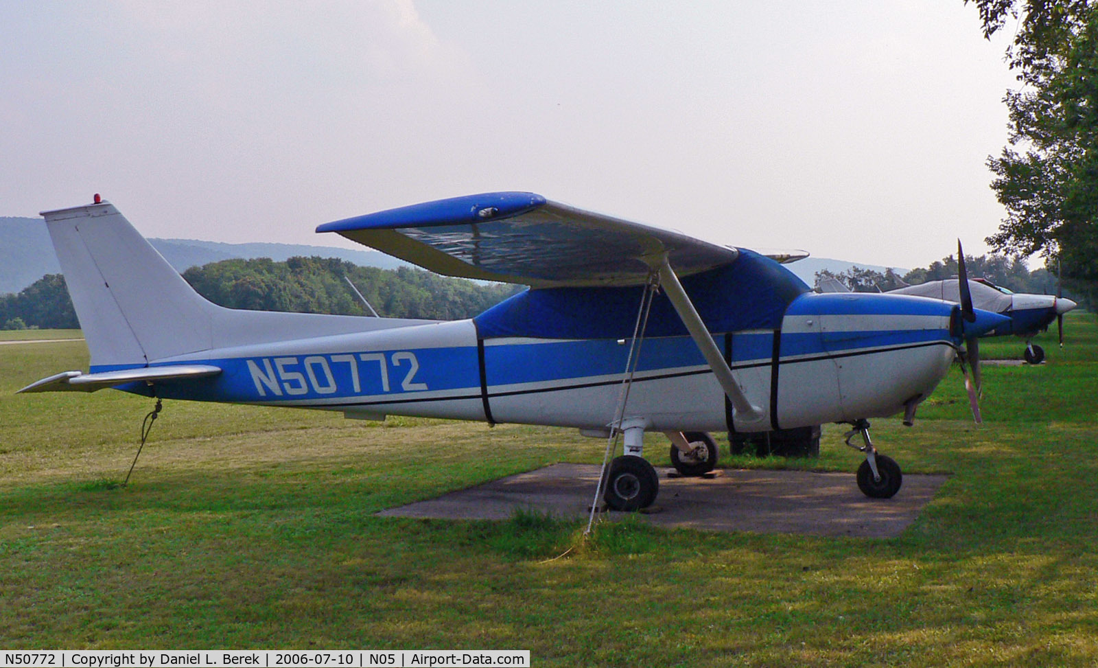 N50772, 1971 Cessna 172L C/N 17259947, 1971-vintage Skyhawk takes refuge under a tarp under the hot evening sun.