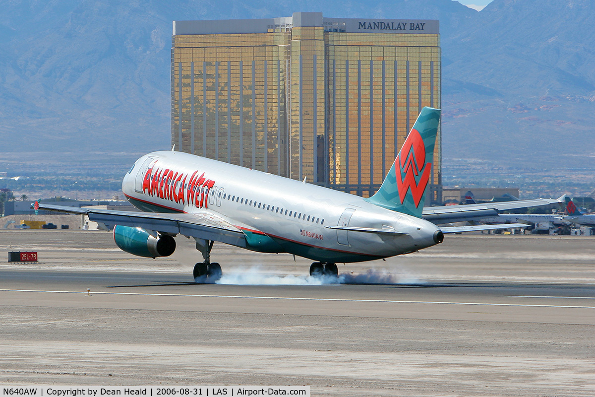 N640AW, 1994 Airbus A320-232 C/N 448, America West N640AW touching down on RWY 25L with the Mandalay Bay Hotel & Resort in the background.