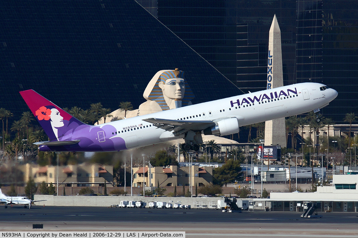 N593HA, 2003 Boeing 767-33A C/N 33424, Hawaiian Airlines N593HA (FLT HAL7) climbing out from RWY 01R, in front of the Luxor Hotel & Casino, enroute to Honolulu Int'l (PHNL).