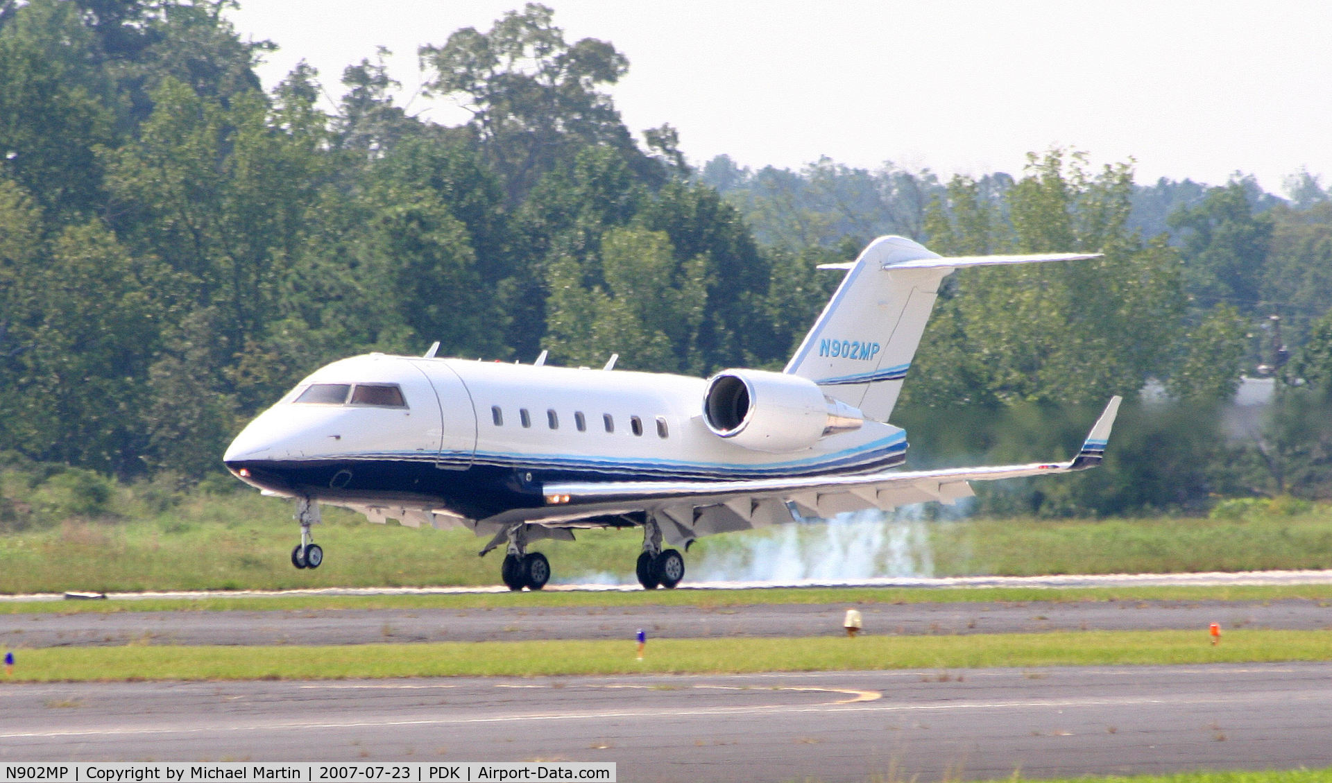 N902MP, 2003 Bombardier Challenger 604 (CL-600-2B16) C/N 5559, Smoking tires on landing.