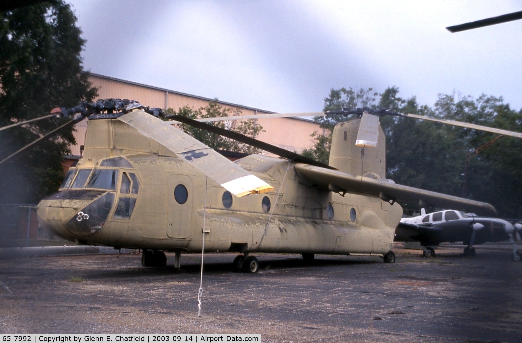 65-7992, 1965 Boeing Vertol CH-47A Chinook C/N B.164, CH-47A at the Army Aviation Museum.  It was modified as protoype BV-347 by stretching the cabin, retractable gear, 4-blade rotors, and wing.  Photo shot through chain-link.