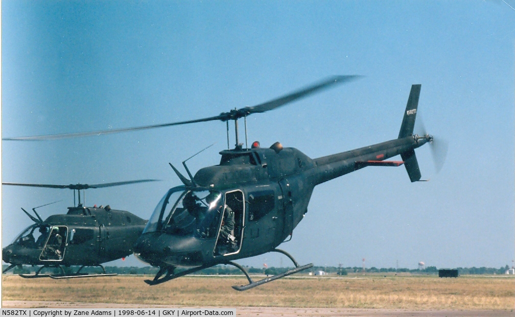 N582TX, 1971 Bell OH-58A C/N 71-20690, 582 in front - Leaving Arlington Muni