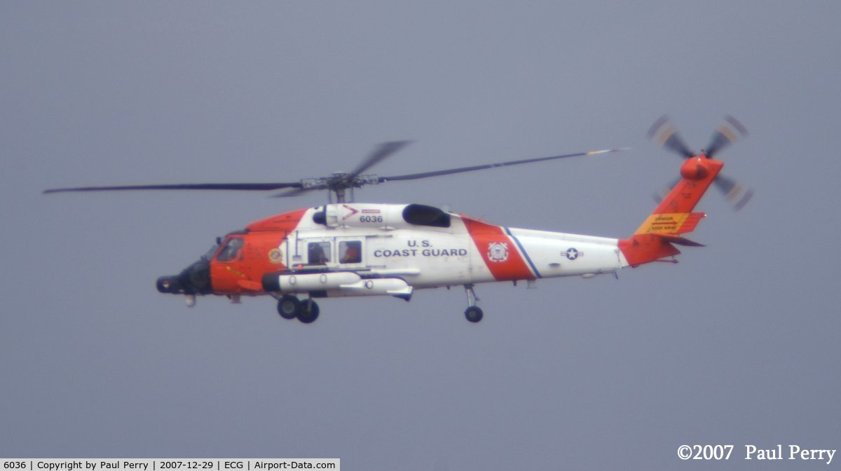 6036, Sikorsky MH-60J Jayhawk C/N 70.1957, A break in the clouds allows the vibrant USCG colors to pop