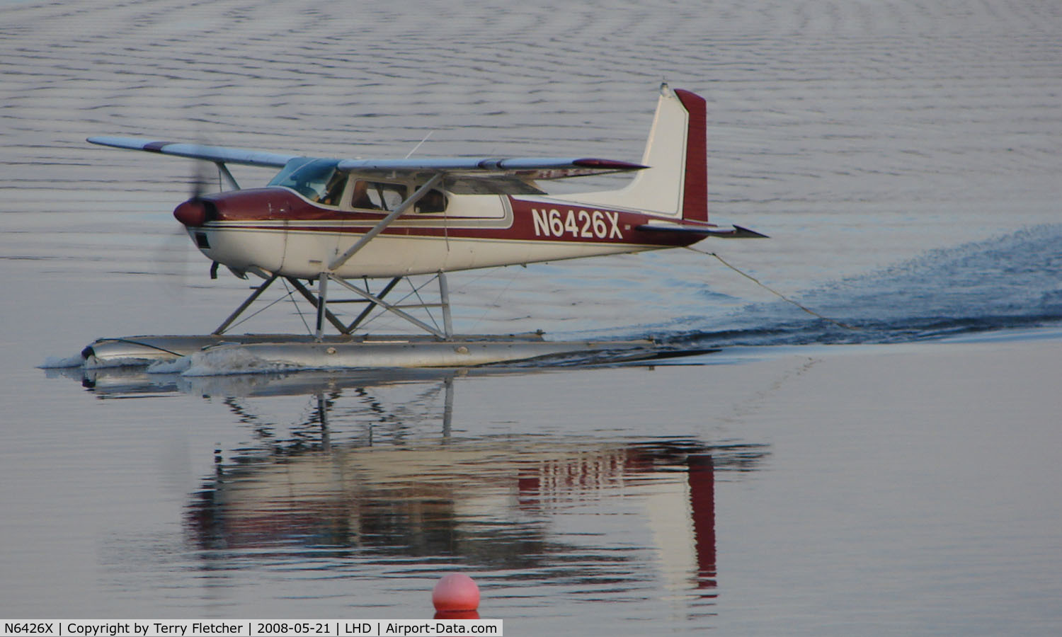 N6426X, 1960 Cessna 180D C/N 18050926, Cessna 180D forms a mirror image on Lake Hood