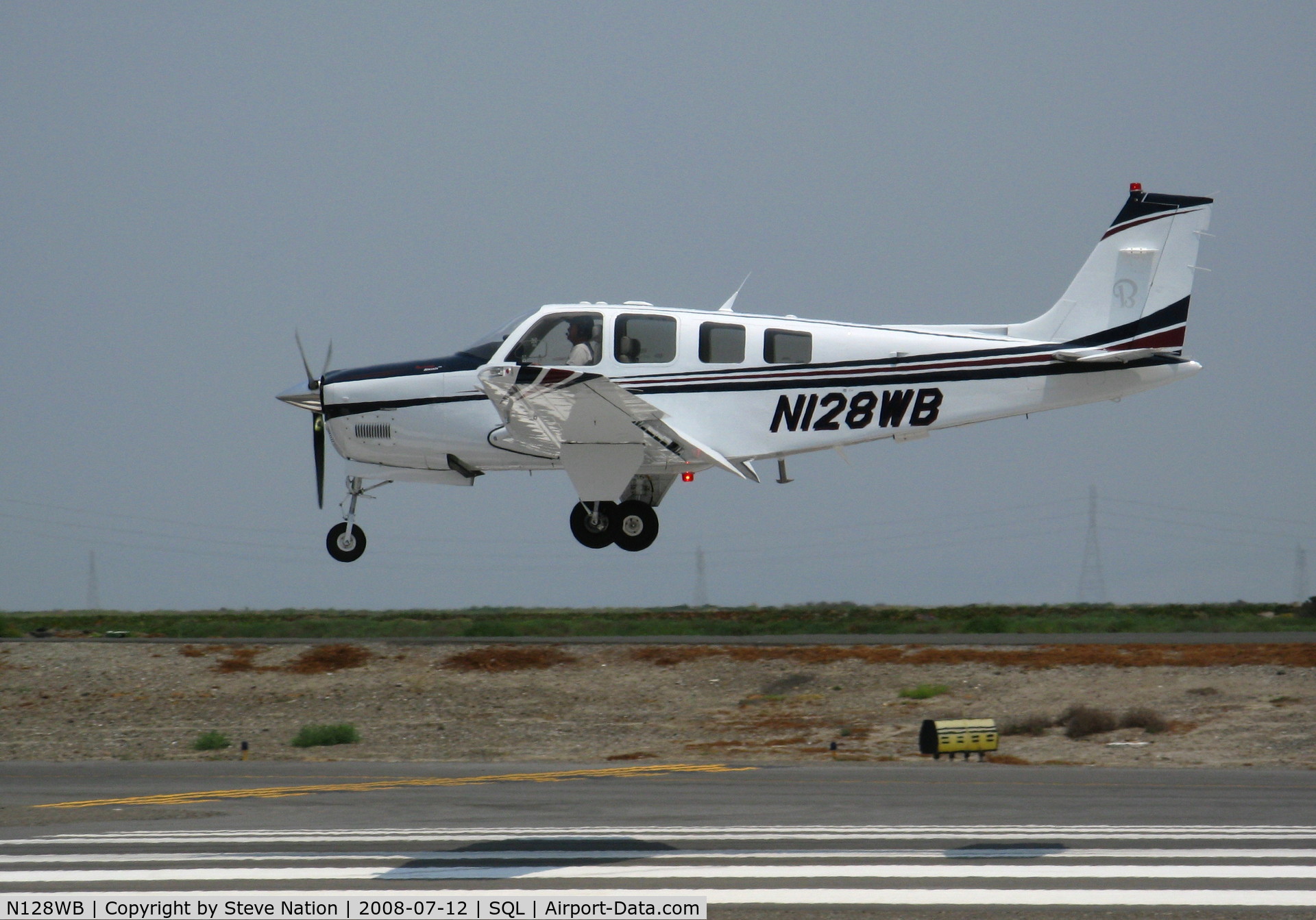 N128WB, Raytheon Aircraft Company G36 C/N E-3662, 2006 Raytheon G36 on final approach in smoky conditions @ San Carlos, CA