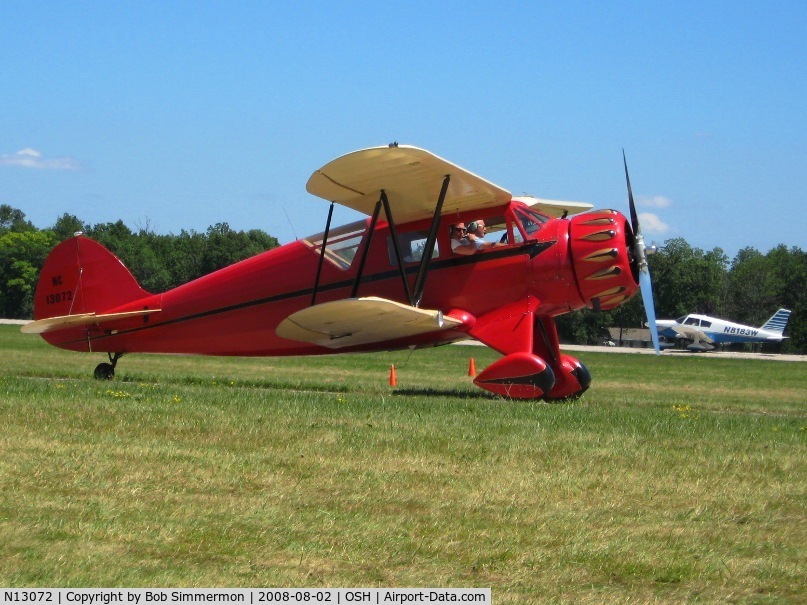 N13072, 1933 Waco UIC C/N 3724, That's N8183W departing RWY 36 in the background.  Airventure 2008 - Oshkosh, WI