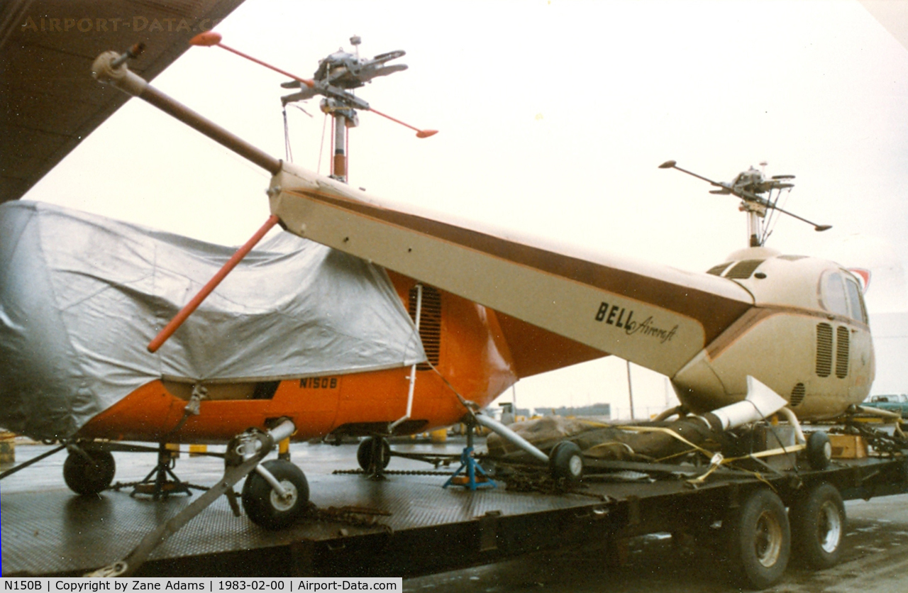 N150B, 2002 Robinson R44 C/N 1199, Bell 47B-3 (the red one) On at truck in Texas being transported to a museum.