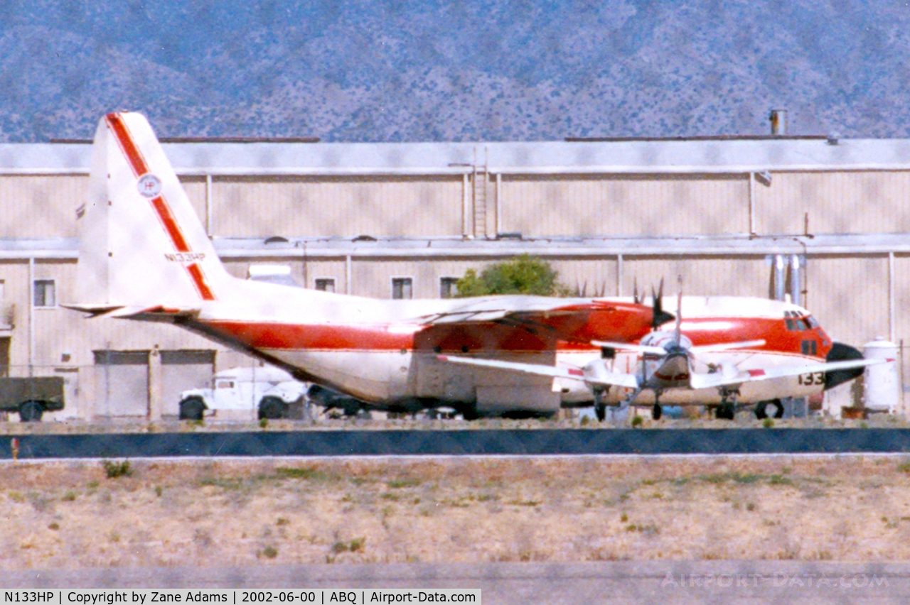 N133HP, 1989 Lockheed C-130A Hercules C/N 182-3189, At Albuquerque (Sorry about shooting through the fence it was too high to see over)