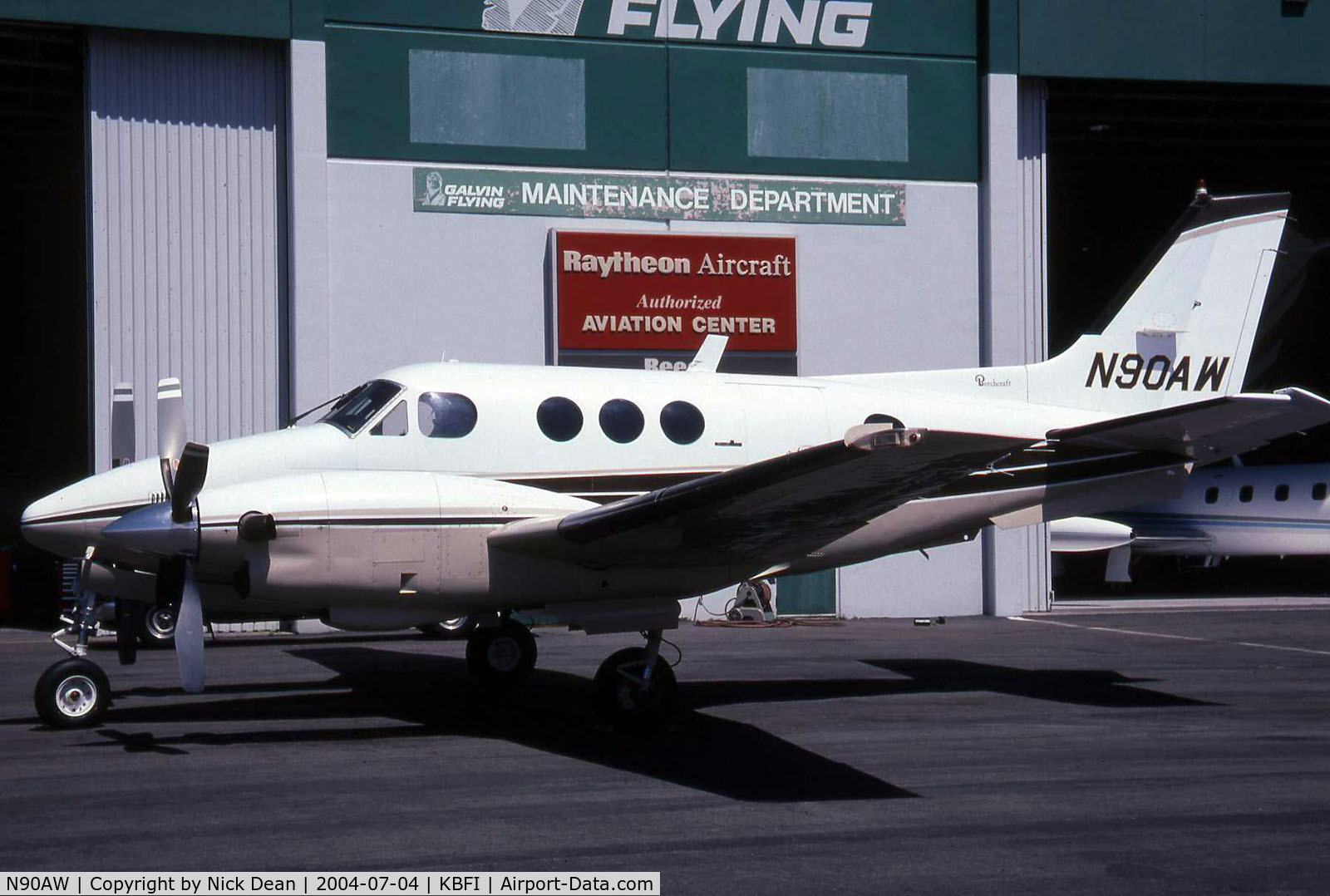 N90AW, 1976 Beech C90 King Air C/N LJ-697, This King Air is parked outside a partially open hangar