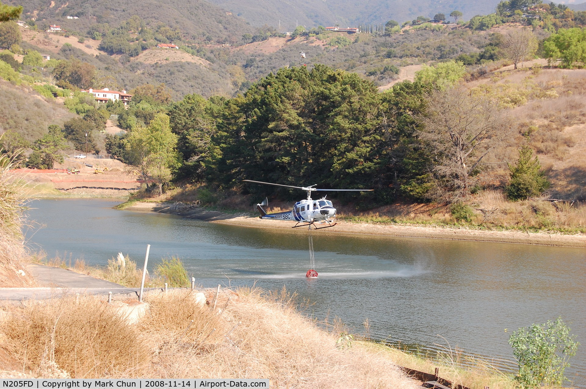 N205FD, Bell UH-1H Iroquois C/N 5305, Filling water bucket at Lauro Reservoir, Santa Barbara, CA. while fighting Tea Fire.