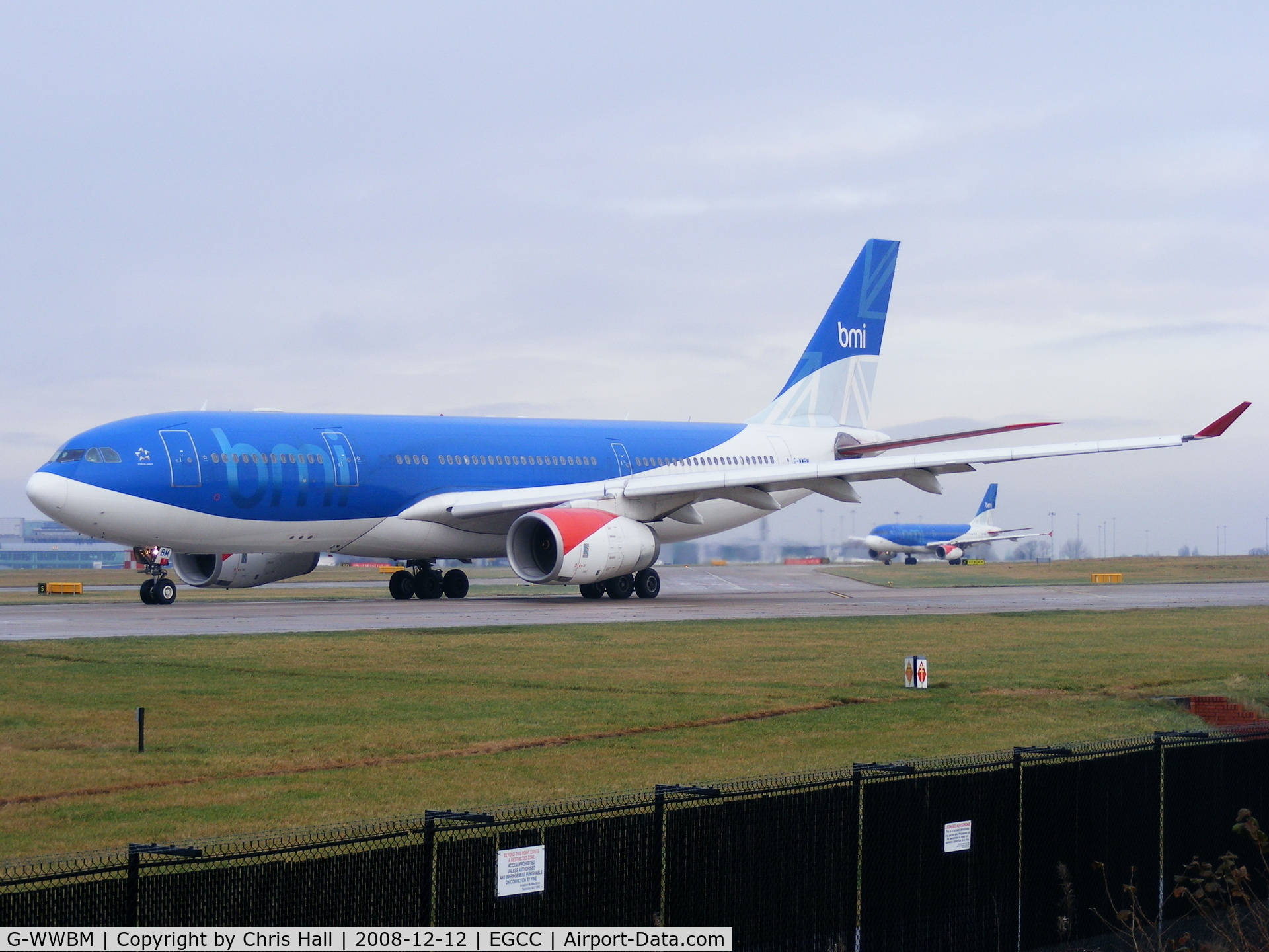 G-WWBM, 2001 Airbus A330-243 C/N 398, with Airbus A319 G-DBCA taxing behind