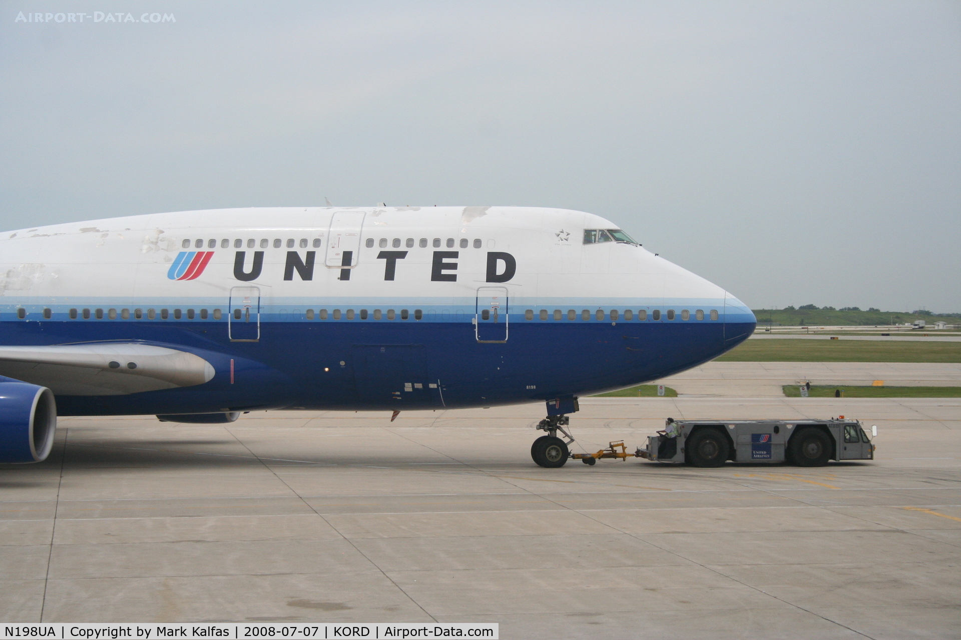 N198UA, 1997 Boeing 747-422 C/N 28716, United Airlines Boeing 747-422, N198UA at KORD pushing back C18 for a trip to ZBAA.