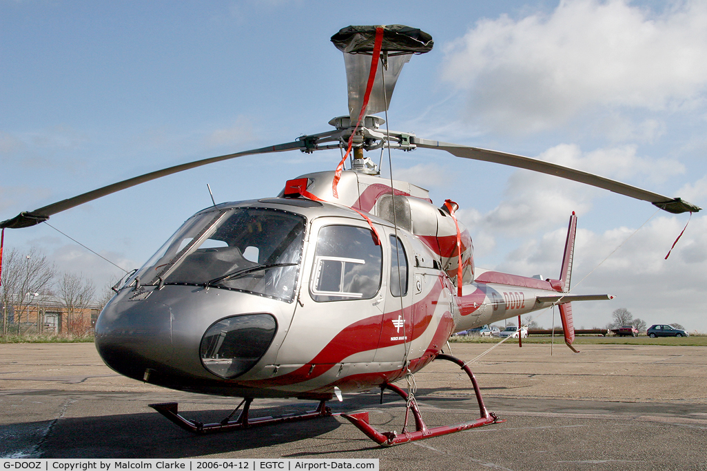 G-DOOZ, 1987 Aerospatiale AS-355F-2 Ecureuil 2 C/N 5367, Aerospatiale AS355F2 at Cranfield Airport. An Ecureil 2 with rotors tied on a windy day!