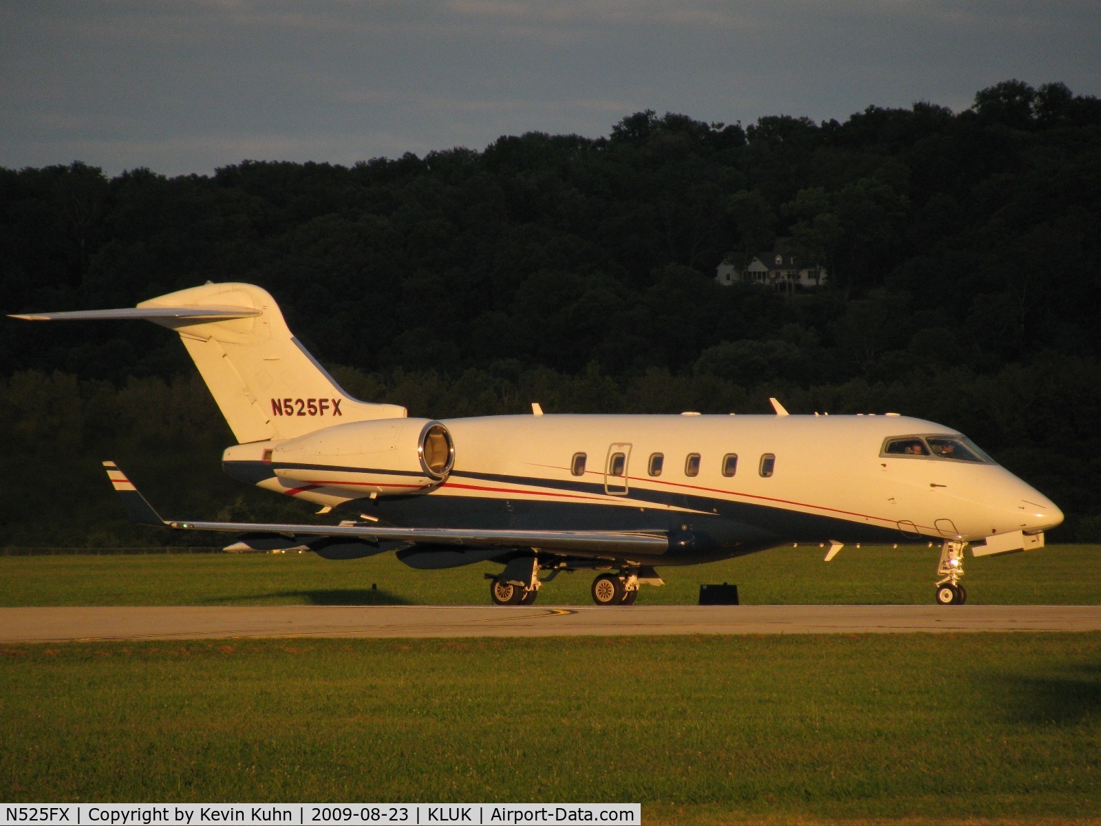 N525FX, 2006 Bombardier Challenger 300 (BD-100-1A10) C/N 20112, Flexjet 525 taxiing by, lit by the setting sun