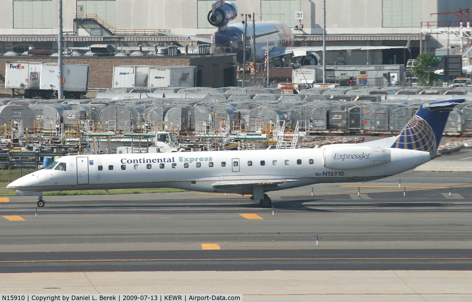 N15910, 2001 Embraer ERJ-145LR (EMB-145LR) C/N 145455, One of many CO ExpressJets taxies past the FedEx terminal at Newark.