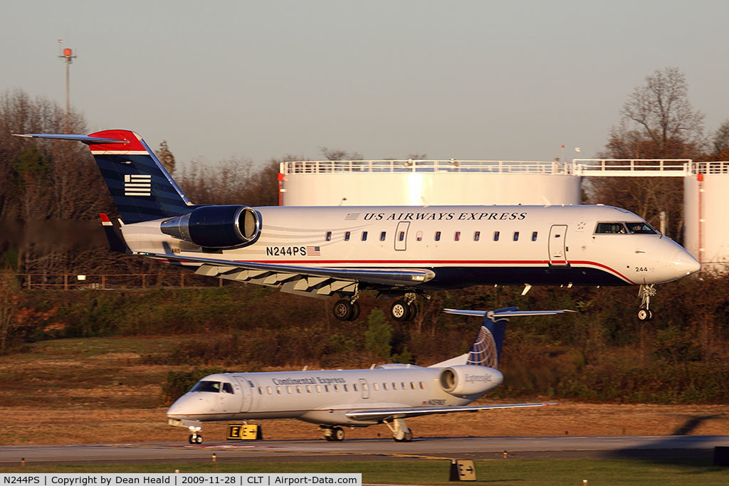 N244PS, 2004 Bombardier CRJ-200ER (CL-600-2B19) C/N 7912, US Airways Express N244PS (FLT JIA392) from Columbia Metropolitan Airport (KCAE) South Carolina landing RWY 18C, while a Continental Express (ExpressJet) ERJ holds short.