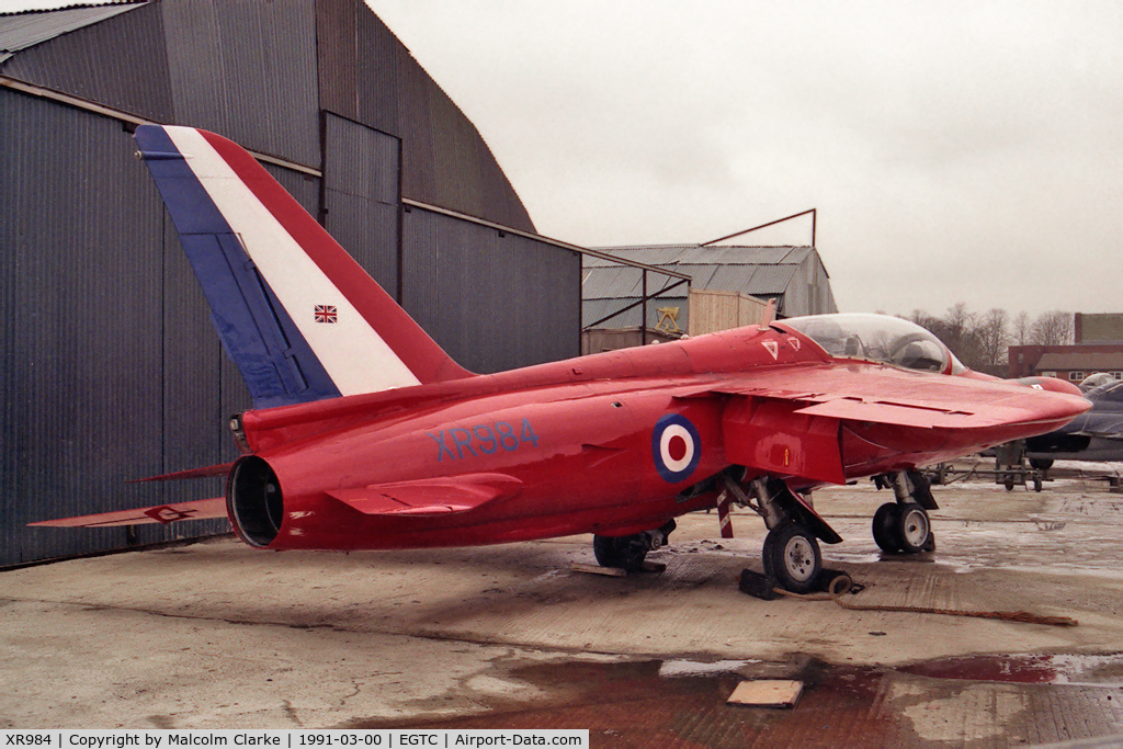 XR984, 1966 Hawker Siddeley Gnat T.1 C/N FL581, Hawker Siddeley Gnat T1. Previously with RAF 4 FTS and No 1 SoTT. Seen here in 1991 at the VAT facility at Cranfield prior to shipment to the USA. Now at the San Diego Flight Museum (N316RF).