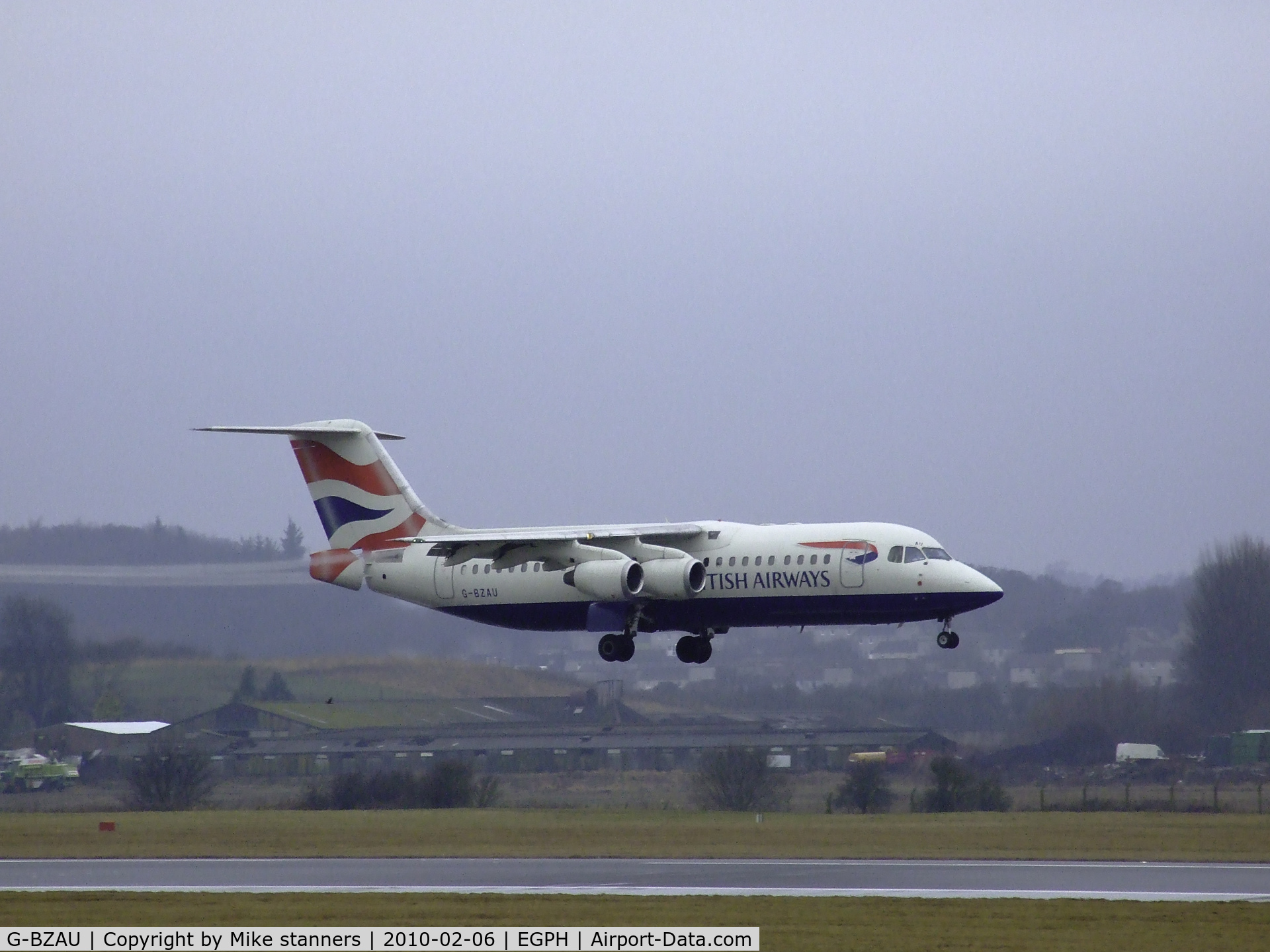G-BZAU, 1998 British Aerospace Avro 146-RJ100 C/N E3328, BA RJ100 Landing on runway 06, pulling long vortices from the flaps and air brake due to the very damp conditions at EDI Today