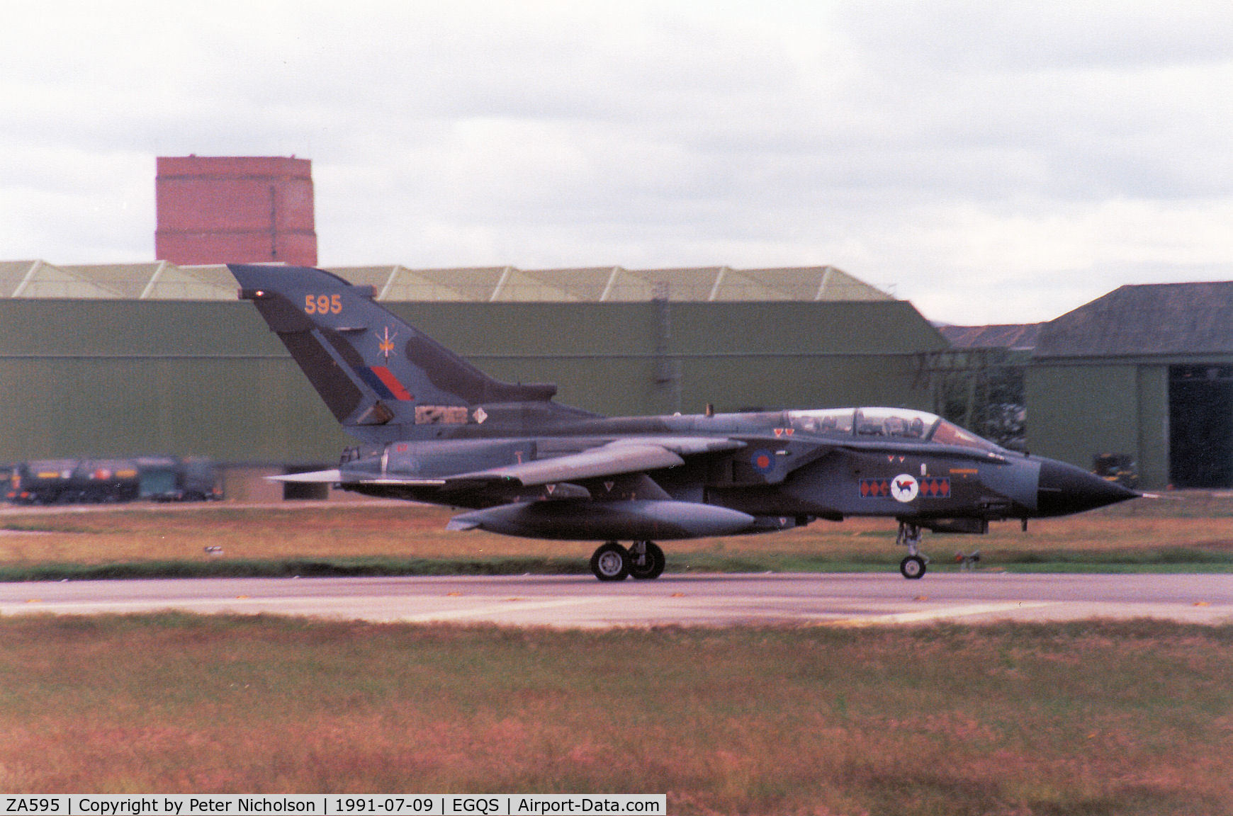 ZA595, 1982 Panavia Tornado GR.1 C/N 112/BT023/3059, Tornado GR.1, callsign Magnum 1, of the Tactical Weapons Conversion Unit at RAF Honington taxying to the active runway at RAF Lossiemouth in the Summer of 1991.